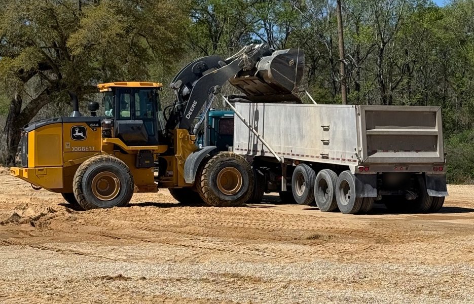 A wheel loader filling a dump trailer with material at a Crawford Aggregate mine